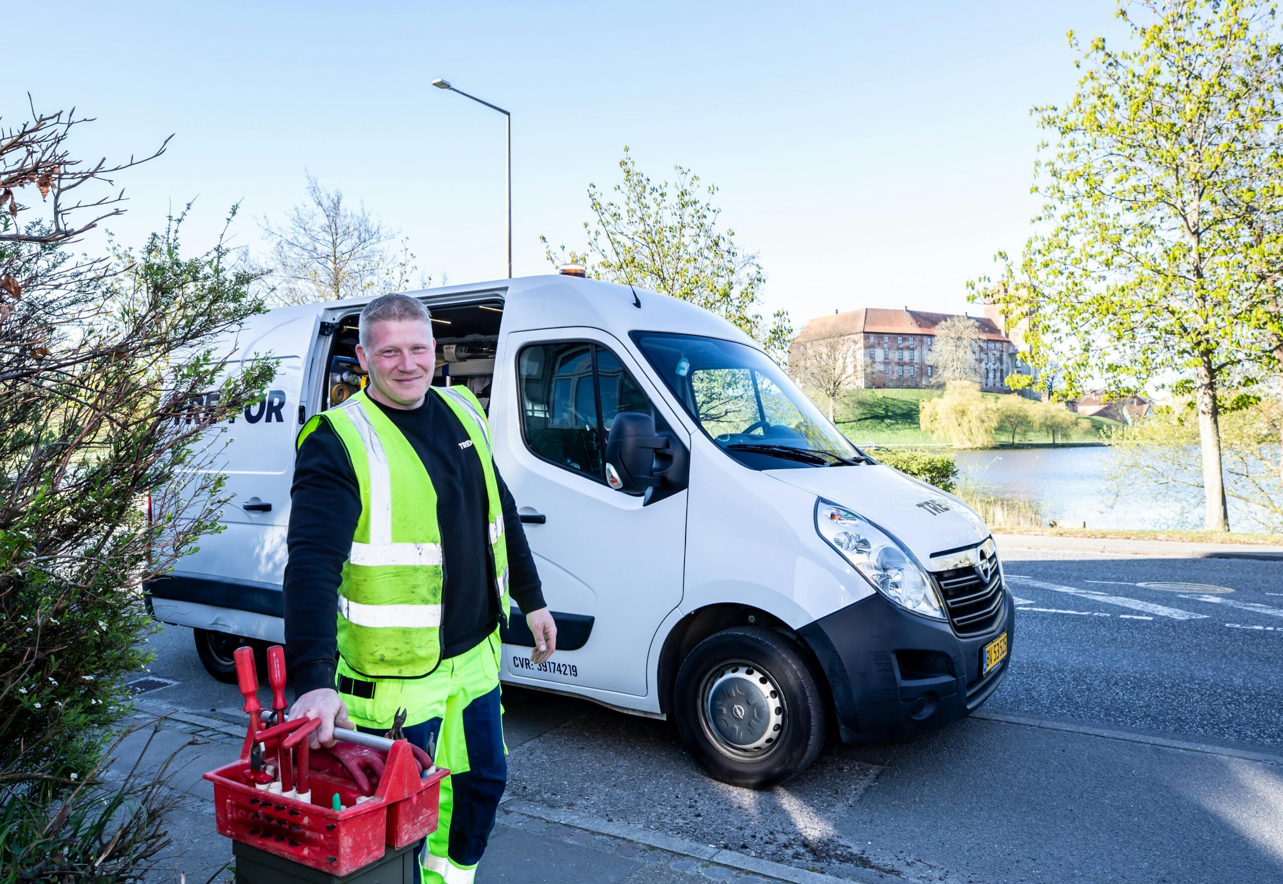 A field service technician beside a work van